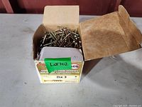 Box of 3 inch wood screws labeled ICE 8x3 with green lot tag. Box nearly full.