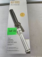 Box front showing Hot Tools Pro Signature Black Ti Collection curling iron image with 1 1/4 inch barrel specification.