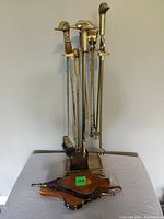 Full view of fireplace tool set on stand with two bellows laid in front