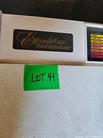 Close-up of the Excalibur Food Dehydrator logo badge and label on the unit's front panel.