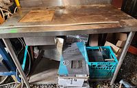 Full front view showing heavy welded stainless steel sink workbench with integrated sink basin beneath and storage shelf below.