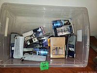 Overview of tote filled with multiple packages of new reading glasses with cases.