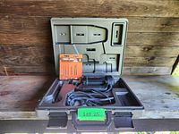 RotoZip Spiral Saw open in carrying case with spare bits set; case molded compartments with spots for tool and accessories