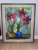 Full view of the original painting showing red amaryllis flowers in pots, framed.