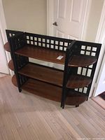 Full view of composite shelving unit showing rectangular and curved shelves with lattice side panels