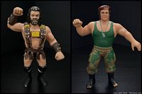 Two WWF wrestling action figures, Hercule Hernandez (left) and Corporal Kirchner (right), displayed side by side with black background.