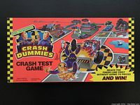 Closed game box showing colorful Crash Test Dummies race-themed artwork on the lid.