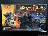 Front view of Dragon Strike game box showing artwork of knights and dragon with product title and logos.