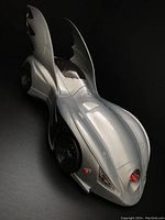 Silver 1994 Batmobile toy with missile detonator, bat-wing fins, and detailed design photographed on a black background.