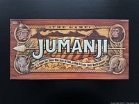 Top view of the Jumanji game box with illustrated wooden board and animal designs.