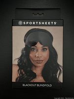 Front of box showing brand, product name, and model wearing the black sleep mask.