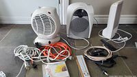 Full lot showing Sunbeam heater, Verilux Happy Light VT15, HomeMax fan, and extension cords