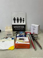 Photo showing miscellaneous items including baby teething mitten, soap dish, hand towel with family figures, metal measuring spoons, meat fork, kids golf balls set, and boxed USB vacuum cleaner.