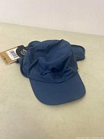 Blue North Face Horizon Sunsheld hat laid out flat, showing soft fabric, wide brim, and ventilation eyelets.