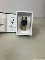 Solios solar watch in box with leaflet visible to the left