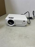 Front view showing projector lens and Toptro brand name.