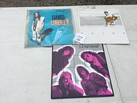 Top view of three vinyl albums laid side by side: David Lindley, Ride, and Starship.