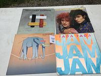 Front view of four album covers showing designs and photos