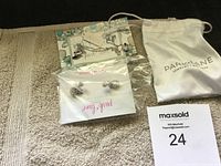 Photo of Park Lane Jewelry earrings and necklace set with original packaging and jewelry pouch on a towel background.