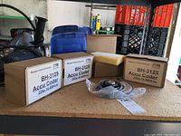 Lot overview showing four boxed encoders and one unit with cable