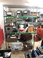 Front view of metal wire shelving unit containing various items to be removed before pickup. Shows shelving grid details and height dimension.