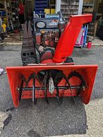 Front view of Ariens snow blower showing auger housing and chute
