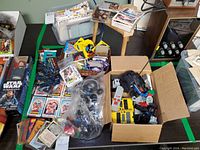 Overview of trading cards and box with Lego vehicle parts on table