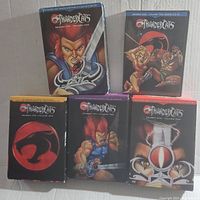 Front view of five DVD boxed set cases from the Thundercats series, showing illustrated covers featuring characters and logos from seasons one and two.