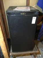 Front view of Danby bar fridge showing black finish and logo