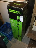 Photo of boxed Greenworks Pro cordless string trimmer showing branding and box condition.