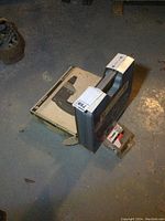 Photo of lot showing the Black & Decker drywall driver box, Crisp Air nailer case, and box of nails.