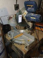 Full view of the miter saw showing base, angle markings, and saw arm with handle.