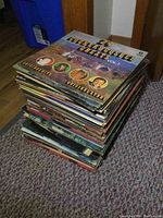Stack of vintage vinyl LP records on floor showing album covers including 24 Country Gospel Greats Vol. 1 and other artists.