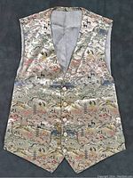 Front view of the silk vest showing the detailed mountain scenery embroidery and decorative buttons on a cream silk background.