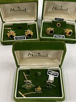 Three velvet covered Marbert presentation boxes each containing pairs of men’s cufflinks and matching tie tacks with labels indicating Gold on Sterling with Onyx and Genuine Jade.