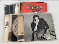 Photo showing arranged vinyl album covers including Al Jarreau, Chuck Mangione, and Bob James with Earl Klugh.