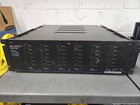 Front view of the Architect Model 760 amplifier showing the full front panel with multiple controls and channel status lights on a workbench.