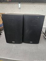 Front view of the pair of Bowers & Wilkins DM600 S3 bookshelf speakers with fabric grille covers.