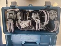 Lot showing all 5 Hamilton Buhl SC-7V headphones inside a blue storage case, coiled cables, silver and gray design.