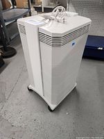 Side view of the white IQAir air purifier on wheels.