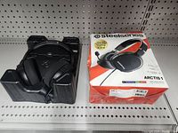 SteelSeries Arctis 1 headset outside of box on shelf.