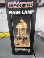 Box of Luminaries Rain Lamp showing product image and features.