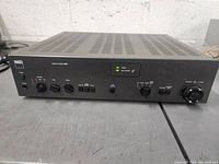Front view of NAD 3130 stereo amplifier showing power switch, headphone jack, speaker selector, bass and treble controls.