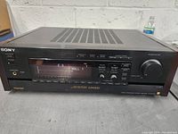 Front view of Sony E2000ESD receiver showing power button, headphone jack, digital display indicating CD input and Hall 1 surround mode, and multiple control buttons on front panel.