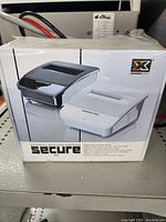 Box front showing black and white versions of the Xigmatek external SATA HDD docking unit.