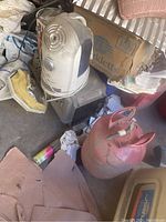 White Sharper Image humidifier placed on top of a black box and various storage items, showing condition and included power cord.