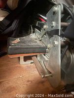 Close-up side view of the screen printing press clamp arm and frame mount.