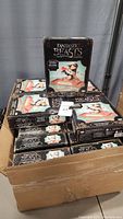 Box of 23 Fantastic Beasts Niffler Challenge games stacked together. Each box features the Niffler collectible game image and branding.
