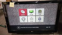Photo shows 42 inch LG flat screen TV powered on with channel settings menu displayed on screen. TV has black bezel and shows static background.