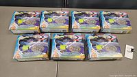 Photo showing 7 sealed boxed Thomas & Friends Adventures Space Mission Track Packs arranged on a table.
